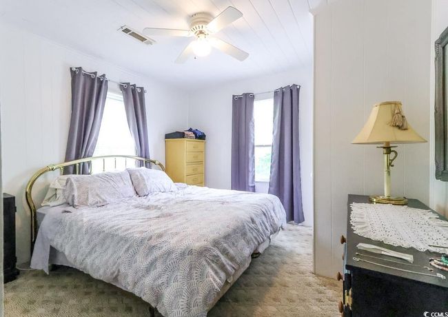 Carpeted bedroom featuring multiple windows and a ceiling fan | Image 35