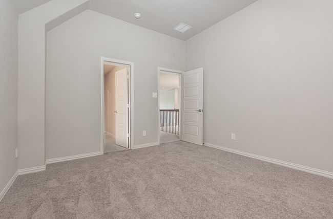 Unfurnished bedroom with carpet floors, baseboards, and high vaulted ceiling | Image 29