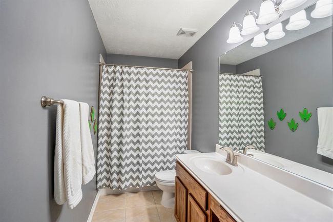 The spacious upstairs full bath offers plenty of vanity space, providing both function and style. The neutral tones and ample counter space make this bathroom a practical and comfortable area for guests. | Image 30