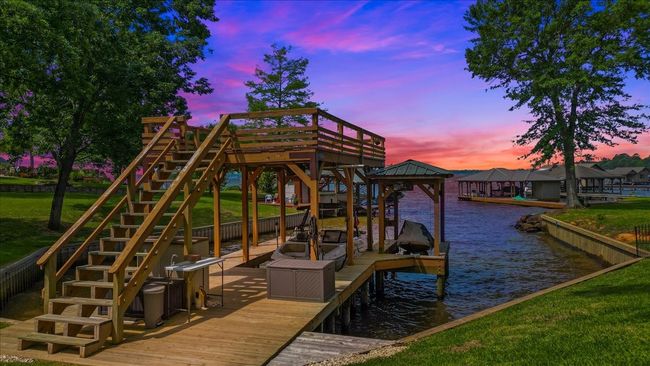 Dock area with stairs, a yard, a water view, and boat lift | Image 4