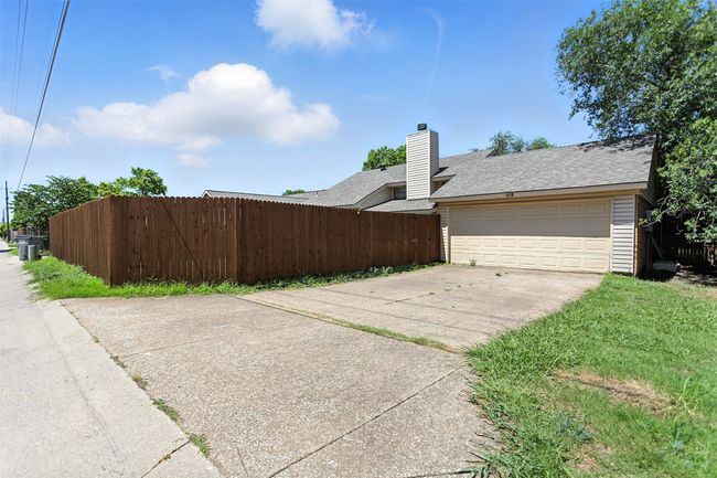 View of property exterior featuring concrete driveway, a shingled roof, and an attached garage | Image 25