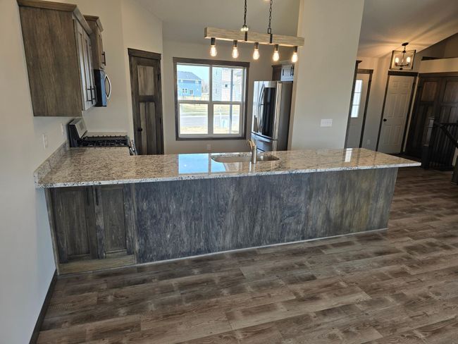 Another view of the kitchen area, large front facing window that brings in lots of natural light. | Image 7