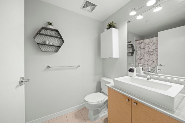 Bathroom with toilet, vanity, and tile patterned flooring | Image 7