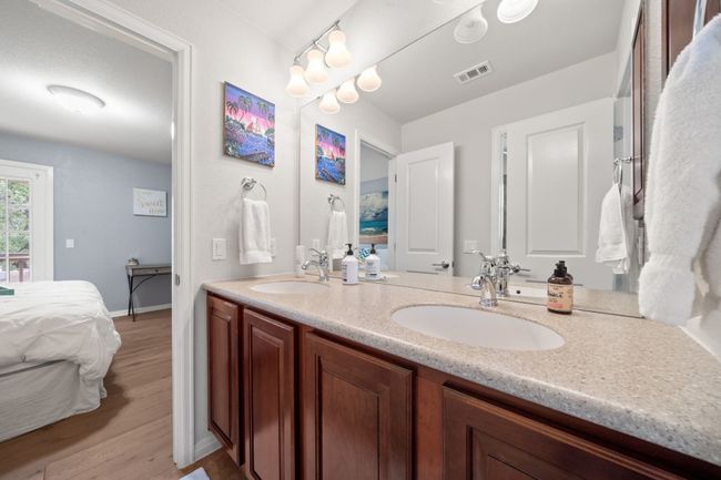 Full bathroom featuring ensuite bath, double vanity, and wood finished floors | Image 21