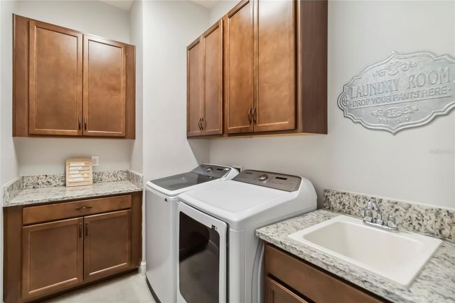 Laundry space with wash tub and additional cabinets | Image 22