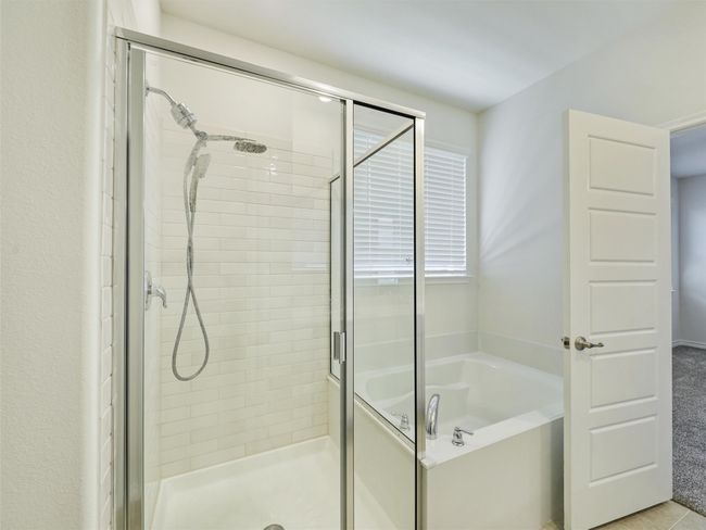 Bathroom featuring a stall shower and a bath | Image 16