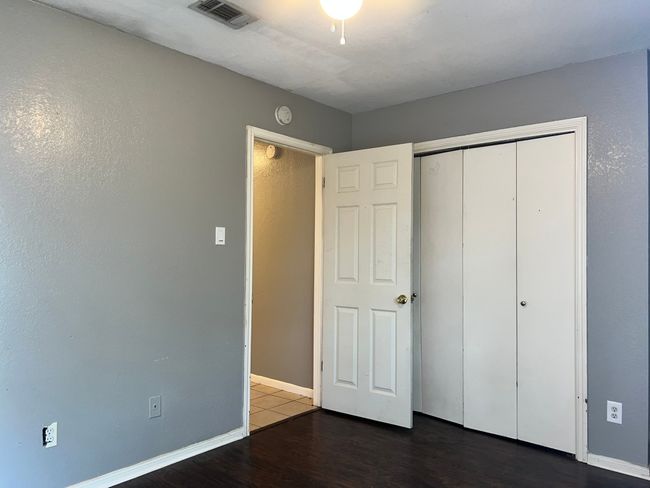 Unfurnished bedroom with wood finished floors and a closet | Image 15