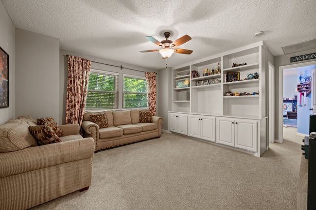 Living room featuring light carpet, a textured ceiling, and ceiling fan | Image 23