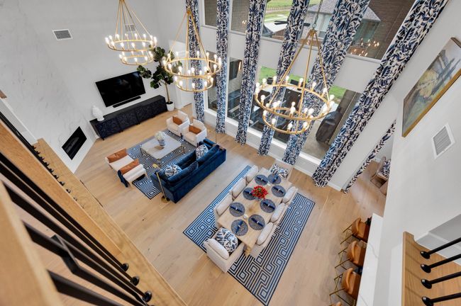 Living room with a chandelier, wood finished floors, and a high ceiling | Image 29