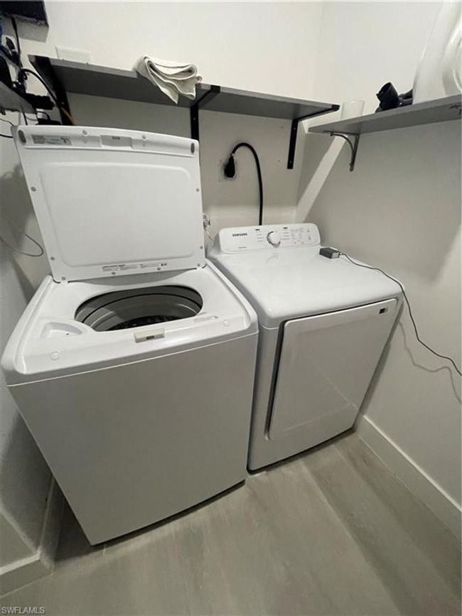 Laundry area with washer and clothes dryer, light hardwood / wood-style flooring, and hookup for an electric dryer | Image 14