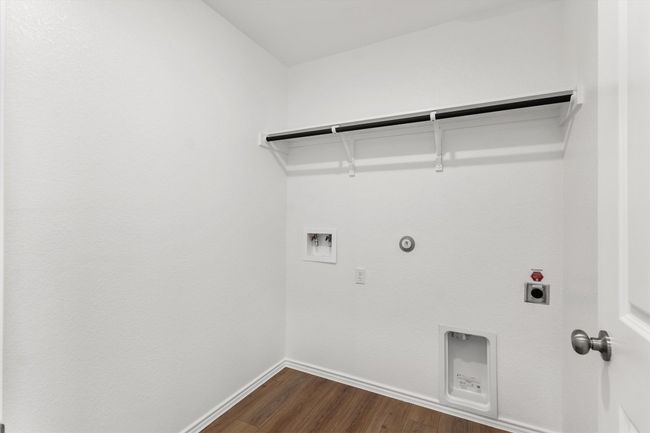 Laundry area with hookup for a gas dryer, washer hookup, electric dryer hookup, and dark wood-style flooring | Image 21