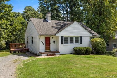 View of front of home with a deck and a front lawn | Image 1