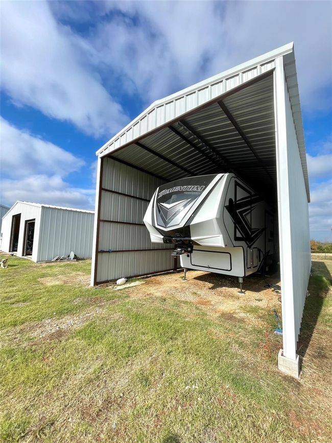 View of pole building with a yard and a detached carport | Image 26