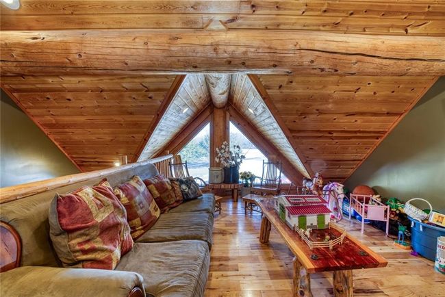 Living room featuring light wood-style floors, wood ceiling, and vaulted ceiling | Image 10