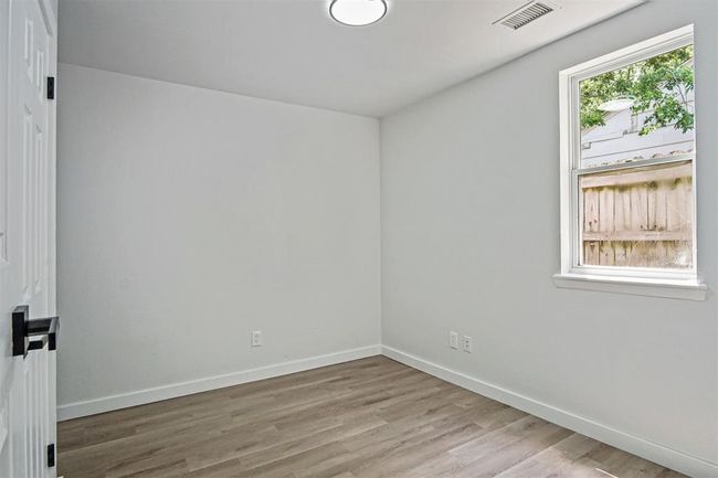 Empty room featuring wood finished floors and baseboards | Image 6