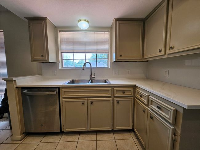 Kitchen featuring dishwasher, light countertops, and light tile patterned floors | Image 10
