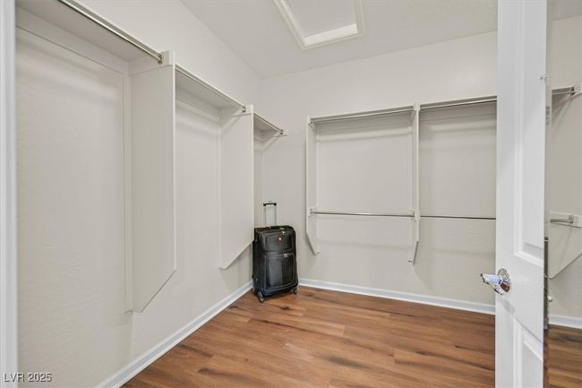 Spacious walk-in closet in primary bedroom with LVP floor | Image 16