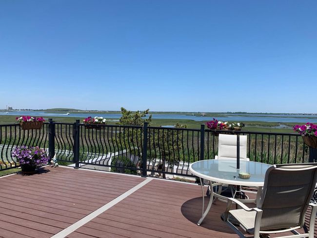 Wooden deck featuring water and city views | Image 14