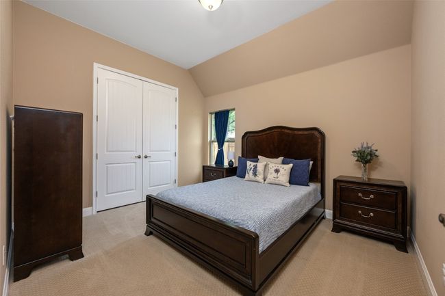 Bedroom featuring light colored carpet, a closet, and vaulted ceiling | Image 27