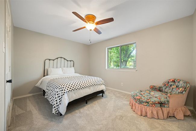 Bedroom with carpet floors, baseboards, and ceiling fan | Image 22