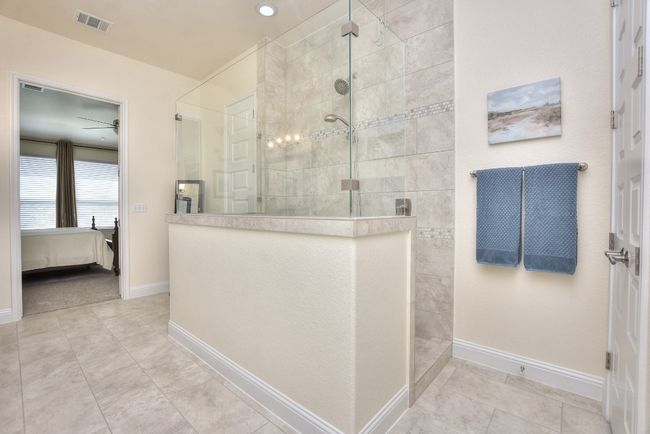 Full bath with visible vents, baseboards, walk in shower, and ensuite bath | Image 26