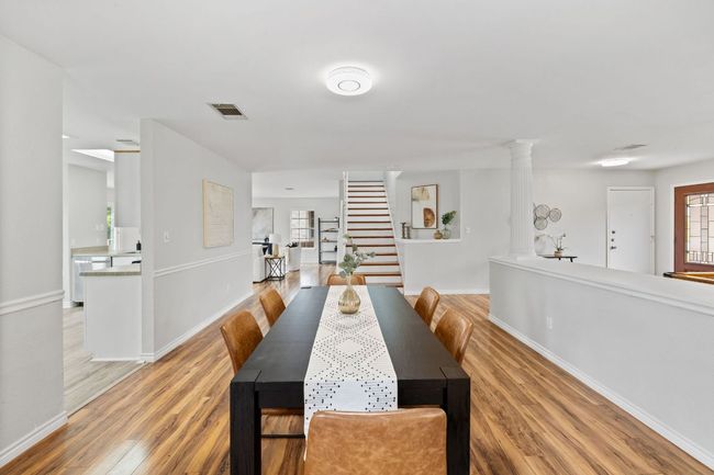 Dining area featuring plenty of natural light, light wood finished floors, and stairs | Image 8