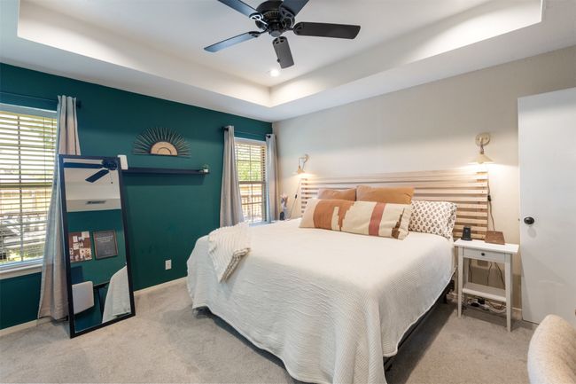 Carpeted bedroom featuring a raised ceiling and a ceiling fan | Image 16