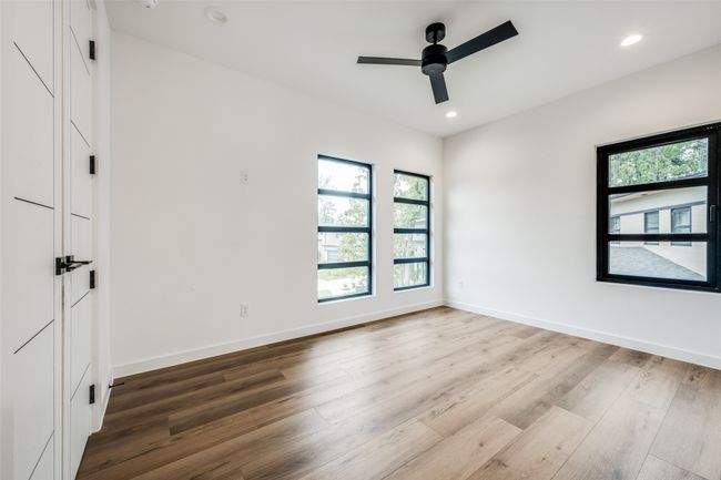 Unfurnished room featuring plenty of natural light, wood finished floors, ceiling fan, and recessed lighting | Image 23