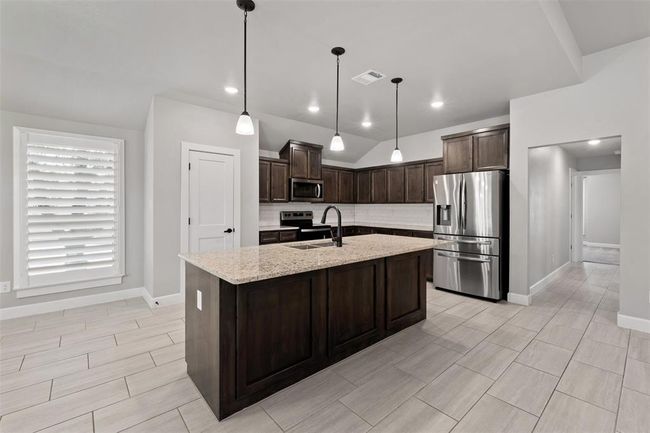 kitchen view with dining area view | Image 12