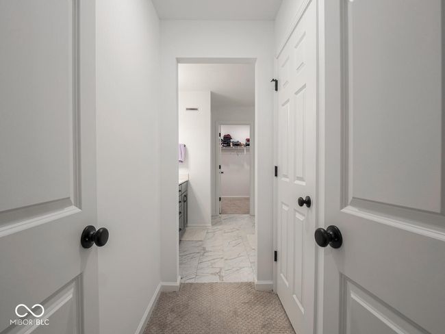 hallway featuring light colored carpet, marble finish floor, and baseboards | Image 36