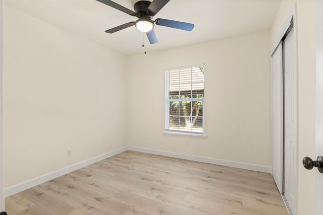 Unfurnished room featuring light wood-style flooring, baseboards, and a ceiling fan | Image 11