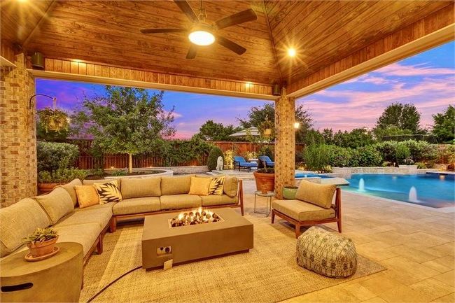 Spacious covered patio with ceiling fans and integrated speaker systems perfect for relaxing or entertaining guests. | Image 41