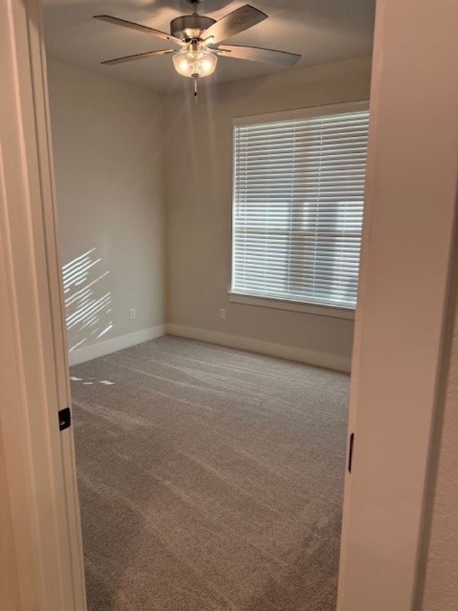 Unfurnished room with carpet and ceiling fan | Image 25