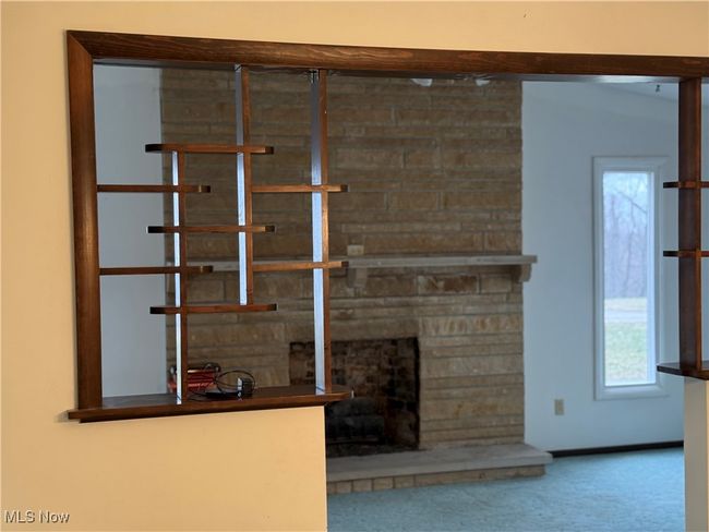 Interior details with a fireplace and carpet flooring | Image 19