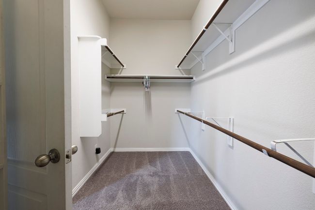 Walk in closet with dark carpet | Image 15
