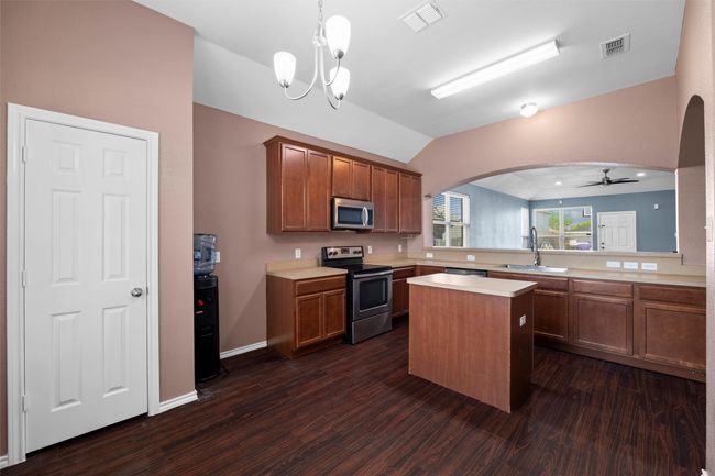 Kitchen with a sink, visible vents, arched walkways, and stainless steel appliances | Image 19
