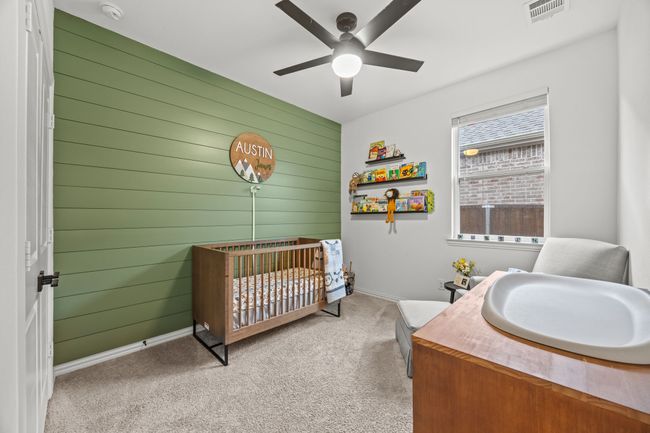 Carpeted bedroom featuring wood walls, baseboards, a nursery area, a sink, and ceiling fan | Image 13