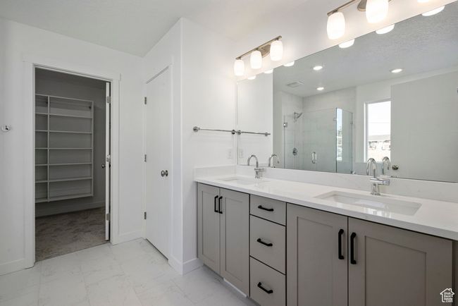 Serene and stylish, this bathroom retreat includes dual sinks for easy mornings, a luxurious soaking tub for quiet nights, and a spacious shower for everyday ease. | Image 20