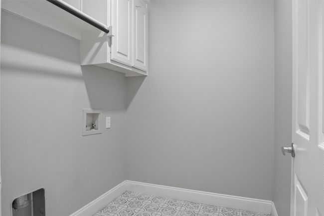 Laundry room featuring hookup for a washing machine, cabinet space, baseboards, and light tile patterned floors | Image 35