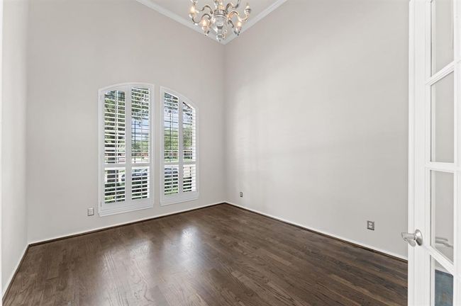 Another view of the office or study area gives privacy with French doors. This spacious room benefits from a large window panel that floods the area with ample natural light. | Image 7