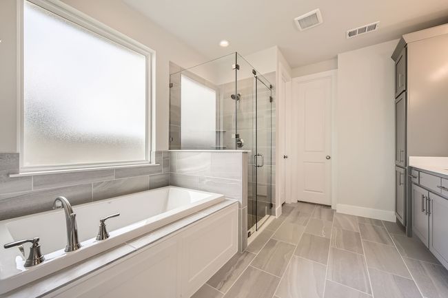 Bathroom with a garden tub, a stall shower, vanity, and recessed lighting | Image 17