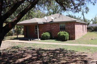 Ranch-style home with a carport and a front lawn | Image 2