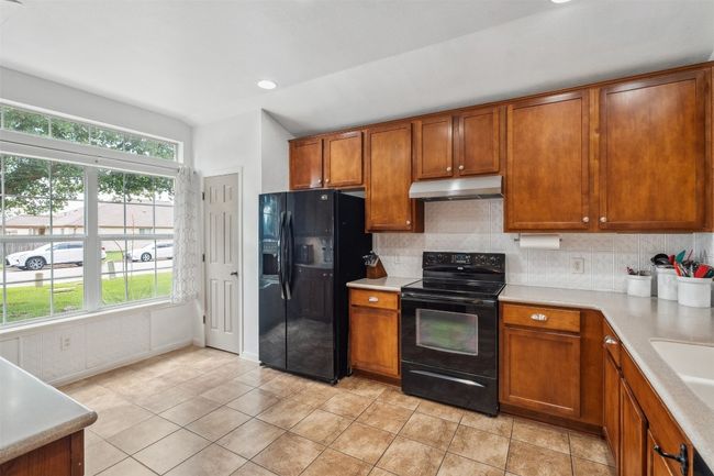 Kitchen window provides warm natural light. | Image 14
