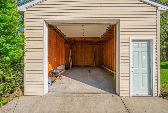 Detached garage is deep with a high ceiling. | Image 29