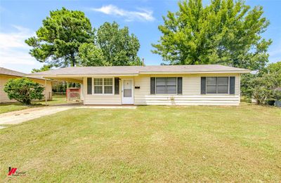 Ranch-style house with a carport and a front yard | Image 3