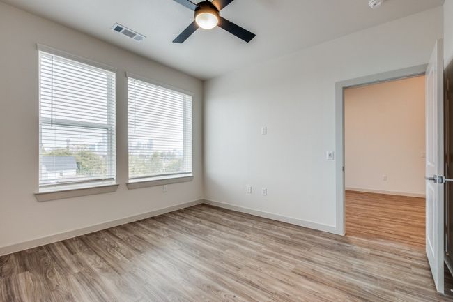 Spare room featuring visible vents, baseboards, light wood-style floors, and a ceiling fan | Image 6