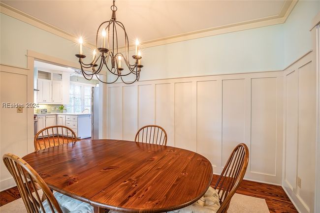 Dining area featuring dark hardwood / wood-style flooring and an inviting chandelier | Image 15