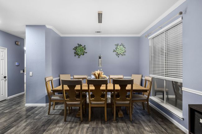 Dining area featuring ornamental molding and dark wood-type flooring | Image 8