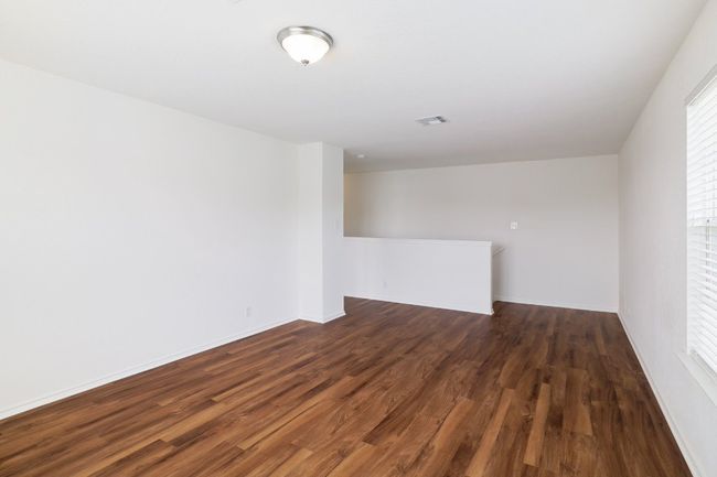 Unfurnished room featuring dark wood-style flooring, visible vents, and baseboards | Image 20