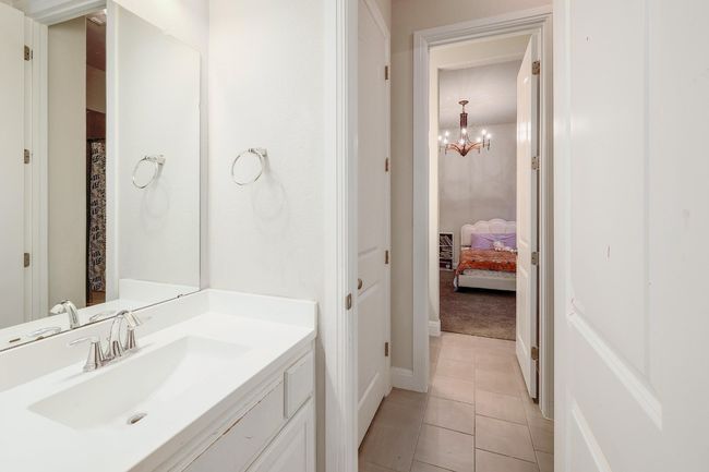 Bathroom featuring vanity, a chandelier, and tile patterned floors | Image 28